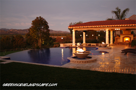 Resort style residential swimming pool and fireplace with outdoor kitchen